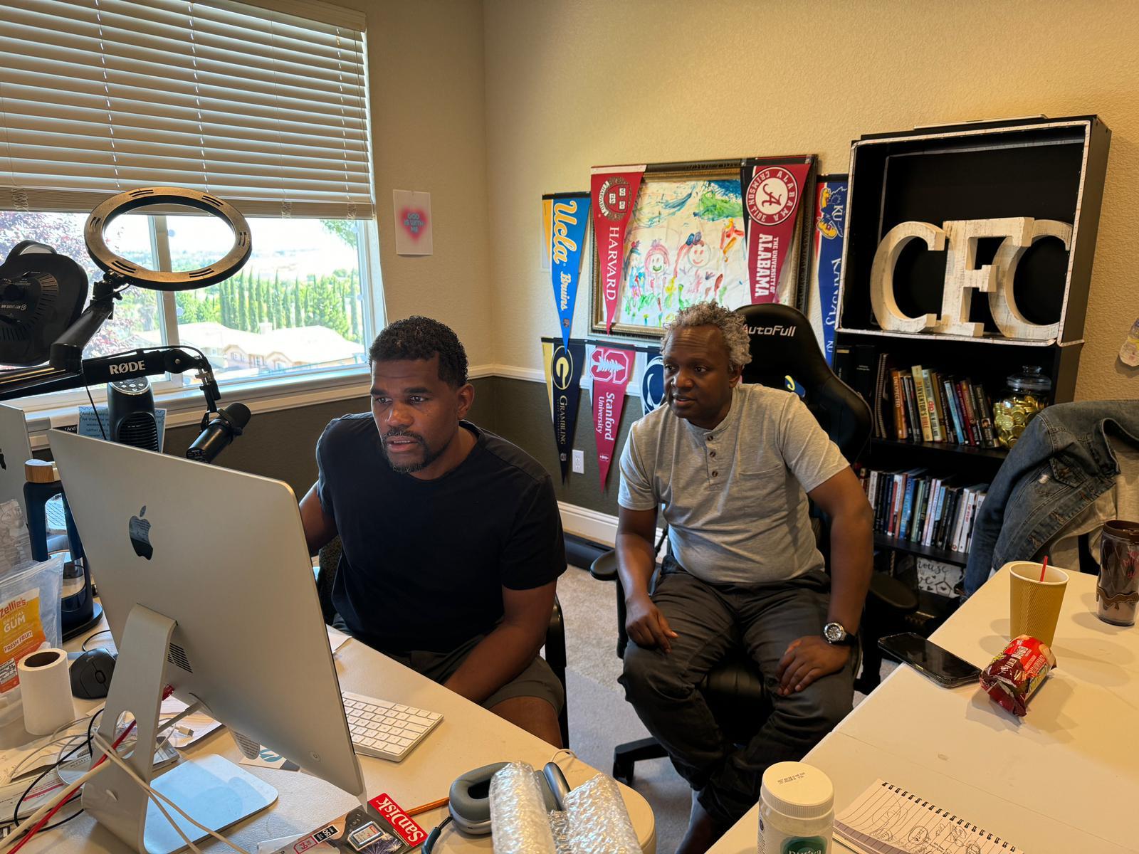 Henry and Joshua working in office